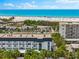 An aerial view of the beachfront community with beach access and lush landscaping at 5600 Beach Way Dr # 201, Sarasota, FL 34242