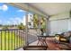 Charming screened balcony with tile flooring, comfortable seating, and pleasant outdoor views at 5600 Beach Way Dr # 201, Sarasota, FL 34242