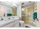 Tidy bathroom features a shower with glass door, sink with vanity, and decorative accents at 5600 Beach Way Dr # 201, Sarasota, FL 34242