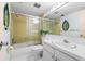 Bathroom featuring tiled shower and tub, vanity with sink, and mirrored wall at 5600 Beach Way Dr # 201, Sarasota, FL 34242
