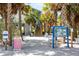 Inviting beach entrance with lush palms, information boards, and a clear path to sandy shores at 5600 Beach Way Dr # 201, Sarasota, FL 34242