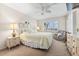 Comfortable bedroom showcasing a bed, window with shutters, sitting chair, and coordinated decor at 5600 Beach Way Dr # 201, Sarasota, FL 34242