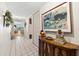 Well lit hallway with a tile floor and view to the living area and balcony at 5600 Beach Way Dr # 201, Sarasota, FL 34242