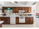 Galley kitchen featuring white appliances, tile floors, and decorative accents throughout at 5600 Beach Way Dr # 201, Sarasota, FL 34242