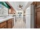Traditional kitchen with wood cabinetry, tile flooring, and bright natural light from the window at 5600 Beach Way Dr # 201, Sarasota, FL 34242