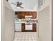Galley-style kitchen featuring tile floors, white appliances, and decorative accents at 5600 Beach Way Dr # 201, Sarasota, FL 34242
