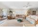 Bright living area featuring large window, plush seating, and view of patio at 5600 Beach Way Dr # 201, Sarasota, FL 34242