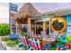 Cozy outdoor seating area with striped chairs around a fire pit, accented by nautical charm and greenery at 5600 Beach Way Dr # 201, Sarasota, FL 34242