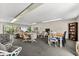 Bright recreation room with comfortable seating, tables, tv, and bookshelves at 5600 Beach Way Dr # 201, Sarasota, FL 34242
