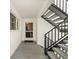 Stairwell with metal railing, stairs and entrance to unit with storm door at 5600 Beach Way Dr # 201, Sarasota, FL 34242