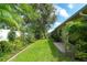 Beautiful backyard featuring lush landscaping, green grass, and a view of the side of the house at 6024 28Th W St, Bradenton, FL 34207