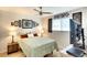 Bedroom with a ceiling fan, picture window, decorative decor, and TV on top of a dresser at 6024 28Th W St, Bradenton, FL 34207