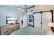 Light and airy bedroom with TV, sliding barn door closet, ceiling fan, and backyard view at 6024 28Th W St, Bradenton, FL 34207