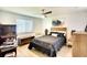 Well-lit bedroom featuring a ceiling fan, decorative wall art, and a cozy quilt on the bed at 6024 28Th W St, Bradenton, FL 34207