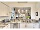 Bright, updated kitchen showcasing granite countertops, a stainless steel dishwasher, and a serving hatch at 6024 28Th W St, Bradenton, FL 34207