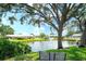Scenic pond view with a fountain, lush greenery, and a community building backdrop at 6024 28Th W St, Bradenton, FL 34207