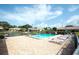 Community pool area with lounge chairs, a sparkling pool, and a tranquil setting at 6024 28Th W St, Bradenton, FL 34207