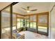 Enclosed sun room with bamboo shades, tile flooring, and comfortable seating with fan at 6024 28Th W St, Bradenton, FL 34207