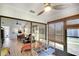Bright sunroom featuring a ceiling fan, comfortable seating, and sliding glass doors to an open living area at 6024 28Th W St, Bradenton, FL 34207