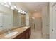 This bathroom features a double vanity, granite countertop, walk in shower, and neutral colors at 6204 Horse Mill Pl, Palmetto, FL 34221