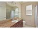 This bathroom features a double vanity with granite counters and a shower with curtain at 6204 Horse Mill Pl, Palmetto, FL 34221