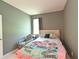 This bedroom has gray walls, a chair and twin sized bed with a fun comforter at 6204 Horse Mill Pl, Palmetto, FL 34221
