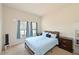 Cozy bedroom featuring a bed with blue covers, side tables, and natural light from two windows at 6204 Horse Mill Pl, Palmetto, FL 34221