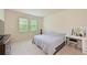 This carpeted bedroom features natural light, blinds, and a vanity with a lighted mirror at 6204 Horse Mill Pl, Palmetto, FL 34221