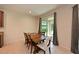 Cozy dining area with tile floors, a wooden table, and natural light from the sliding door at 6204 Horse Mill Pl, Palmetto, FL 34221