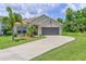Charming single-story home with a two-car garage, well-kept lawn, and mature landscaping at 6204 Horse Mill Pl, Palmetto, FL 34221