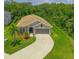 Aerial view of a single-story home with a well-manicured lawn and a long, curving driveway at 6204 Horse Mill Pl, Palmetto, FL 34221