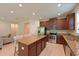 Modern kitchen with an island, granite countertops, and stainless steel appliances at 6204 Horse Mill Pl, Palmetto, FL 34221