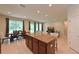 Open kitchen and dining area with an island, granite countertops, and tile flooring at 6204 Horse Mill Pl, Palmetto, FL 34221