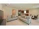 Open-concept living area featuring tile flooring, neutral walls, and comfortable seating at 6204 Horse Mill Pl, Palmetto, FL 34221