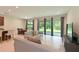 Spacious living area with tile floors, large windows, and a view of the outdoor space at 6204 Horse Mill Pl, Palmetto, FL 34221