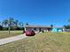 Inviting single-story home with a spacious front yard, attached garage, and convenient driveway at 6405 Myrtlewood Rd, North Port, FL 34287