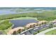 Scenic aerial shot of a condominium complex with views of a pond, golf course, and natural wetlands at 6515 Grand Estuary Trl # 208, Bradenton, FL 34212