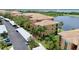 An elevated view of a neighborhood featuring a lake and low-rise condominiums at 6515 Grand Estuary Trl # 208, Bradenton, FL 34212
