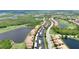 Expansive aerial view showcasing a community of condos, landscaping, and ponds amid a natural preserve at 6515 Grand Estuary Trl # 208, Bradenton, FL 34212