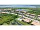 An elevated view of a neighborhood featuring a pool, ponds, and low-rise condominiums at 6515 Grand Estuary Trl # 208, Bradenton, FL 34212