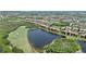 Drone shot of low-rise condos near golf course and lake, offering serene waterfront living at 6515 Grand Estuary Trl # 208, Bradenton, FL 34212