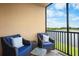 Screened balcony with comfortable seating and a peaceful lake view at 6515 Grand Estuary Trl # 208, Bradenton, FL 34212