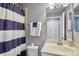 Bathroom featuring a blue and white striped shower curtain and a white sink at 6515 Grand Estuary Trl # 208, Bradenton, FL 34212