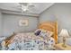 Bedroom with a bed featuring a patterned quilt, beside a decorative lamp at 6515 Grand Estuary Trl # 208, Bradenton, FL 34212