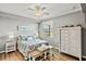 Comfortable bedroom with a ceiling fan, a bench, and a 