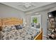 Well-lit bedroom leading to a seating area, complete with a decorative bookshelf at 6515 Grand Estuary Trl # 208, Bradenton, FL 34212