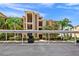 Residential building with covered parking and lush landscaping surrounding the units at 6515 Grand Estuary Trl # 208, Bradenton, FL 34212