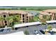 Picture of condominiums with carports nestled among mature palms and lush greenery overlooking a lake at 6515 Grand Estuary Trl # 208, Bradenton, FL 34212