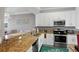 Kitchen featuring granite countertops, stainless steel appliances, and white cabinets at 6515 Grand Estuary Trl # 208, Bradenton, FL 34212