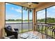 Screened lanai with seating area, offering views of the pond and natural surroundings at 6515 Grand Estuary Trl # 208, Bradenton, FL 34212